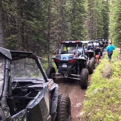 a truck driving down a dirt road
