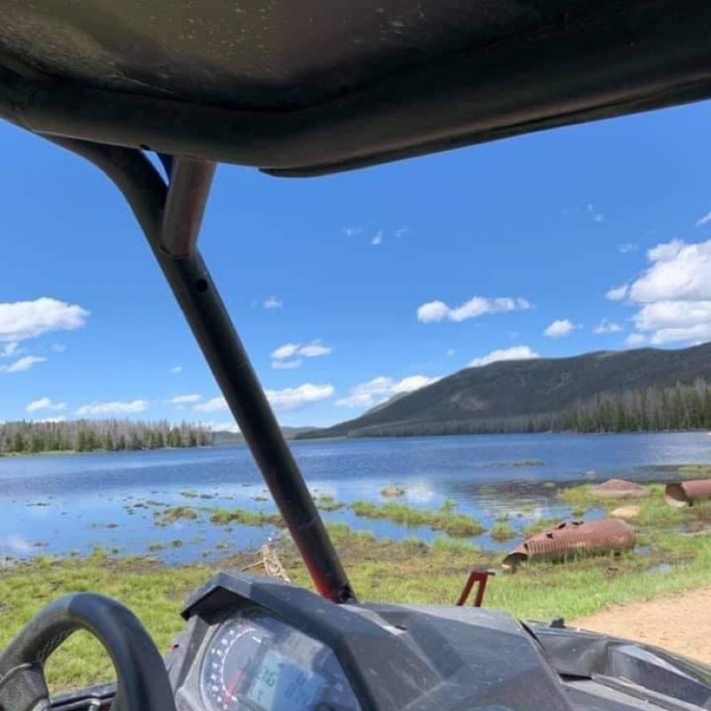 a car parked in front of a body of water