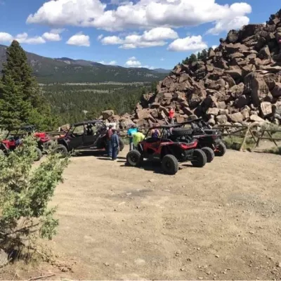 a motorcycle is parked on the side of a dirt road
