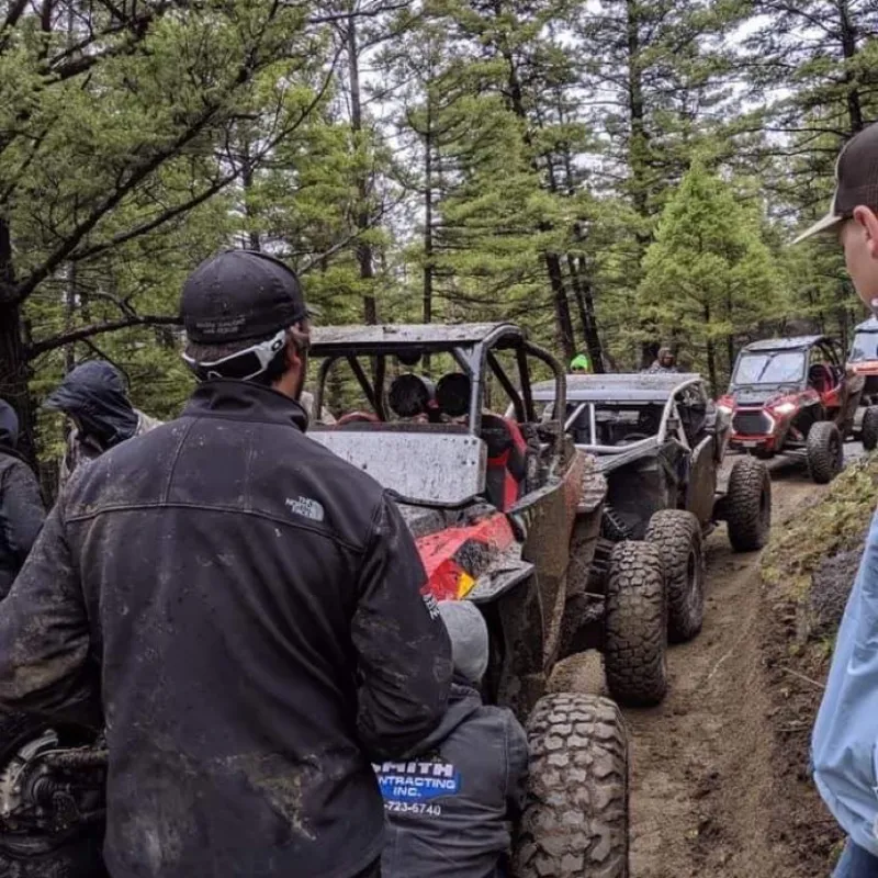 a group of people standing in the dirt