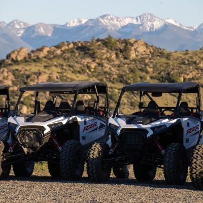 a group of people sitting around a car