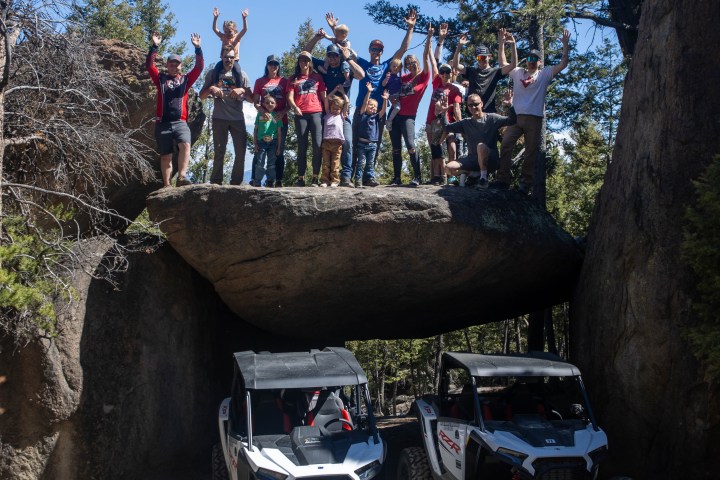 a group of people sitting on a rock