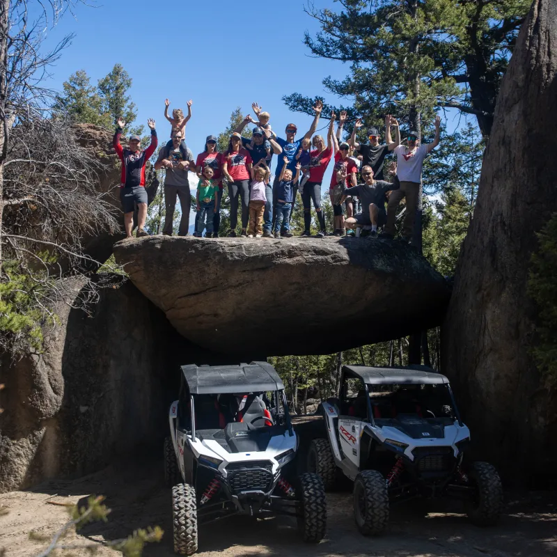 a group of people sitting on a rock