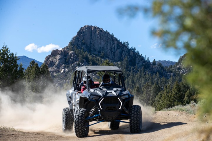 a truck driving down a dirt road