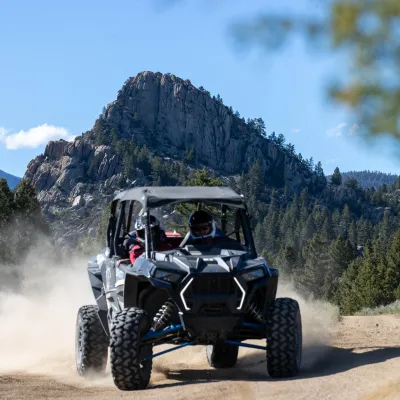 a truck driving down a dirt road